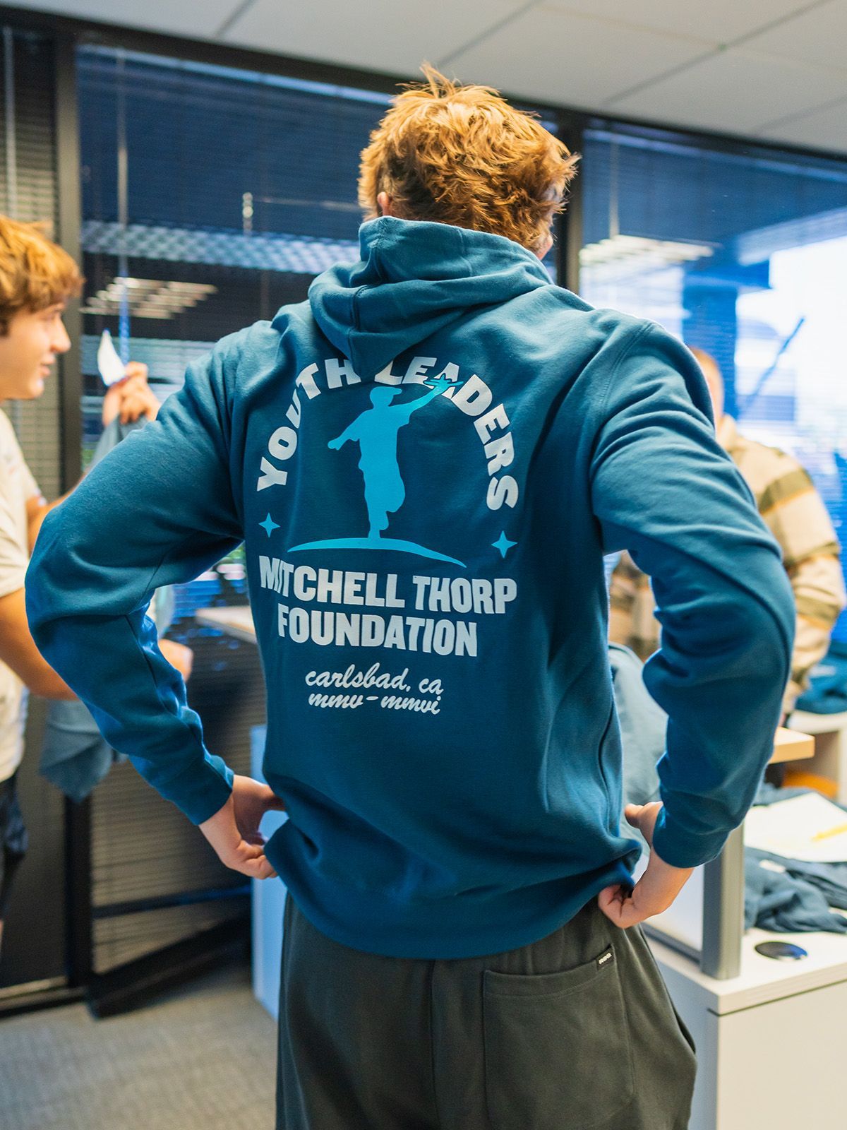 Man wearing teal hoodie with 