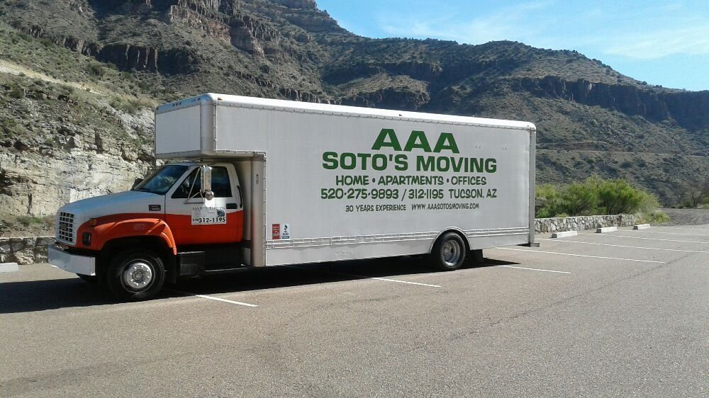 A aaa soto 's moving truck is parked on the side of the road