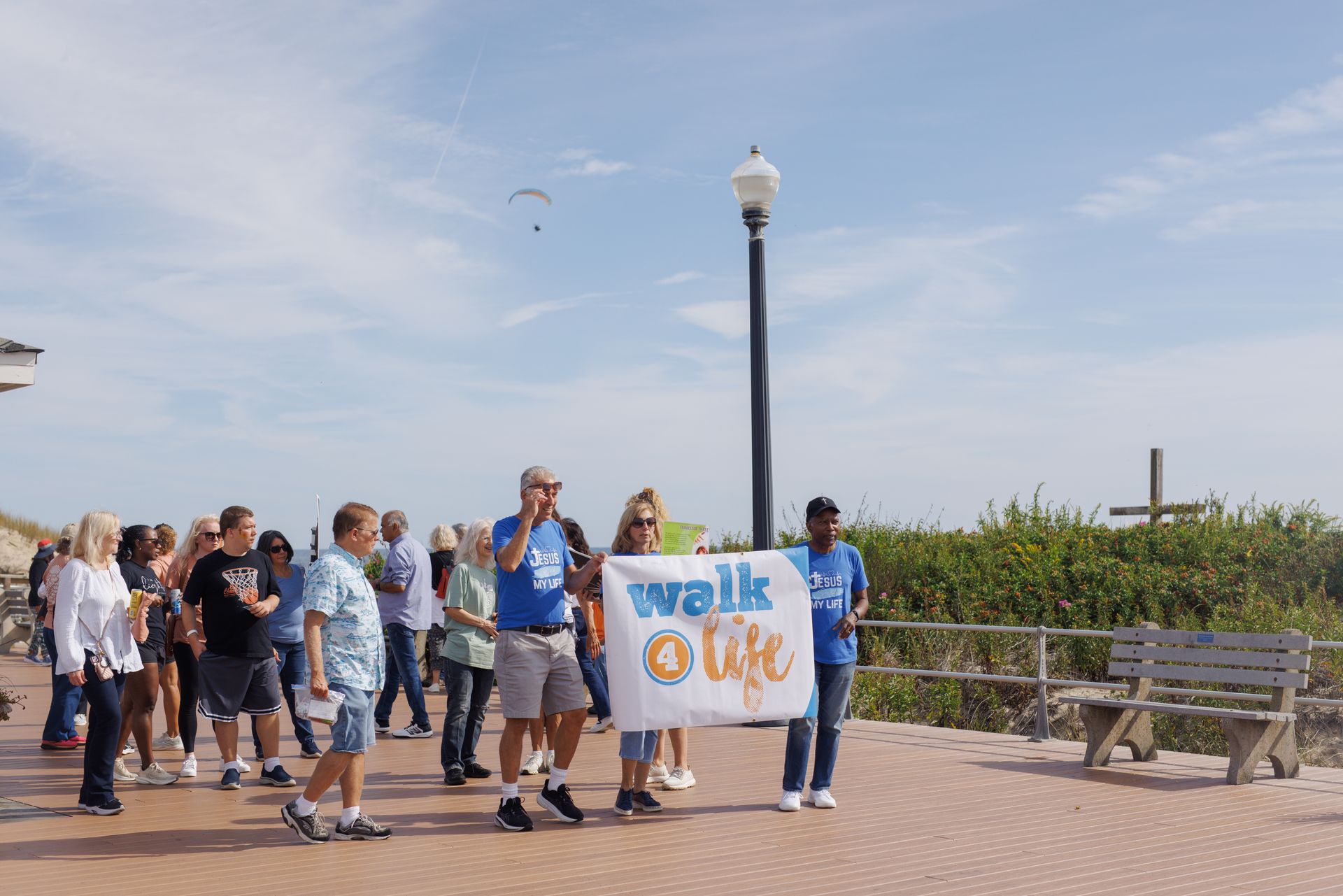People walking on a boardwalk with a