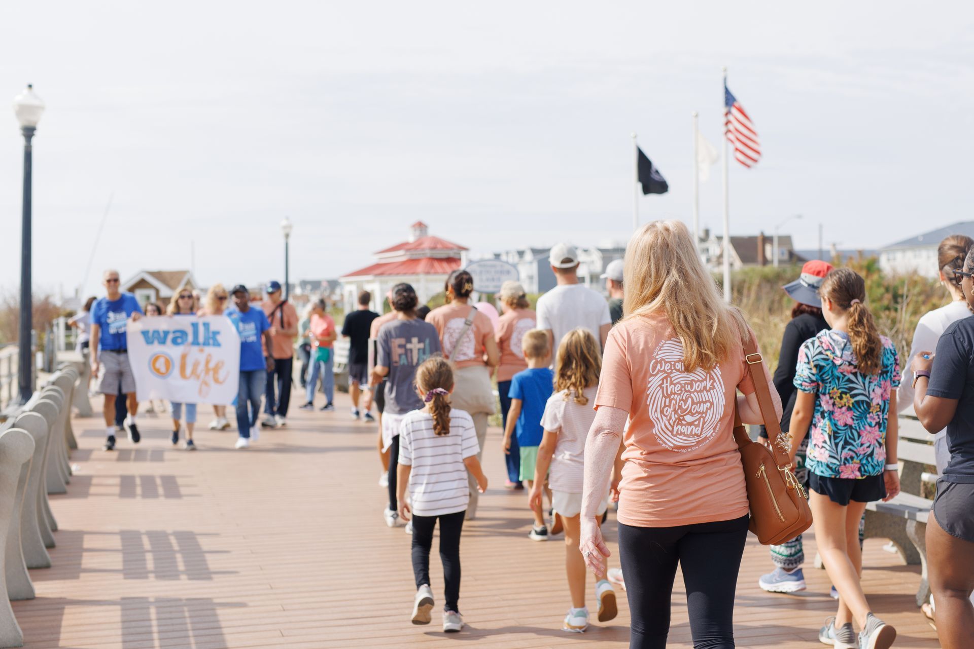 People walk on a boardwalk, a