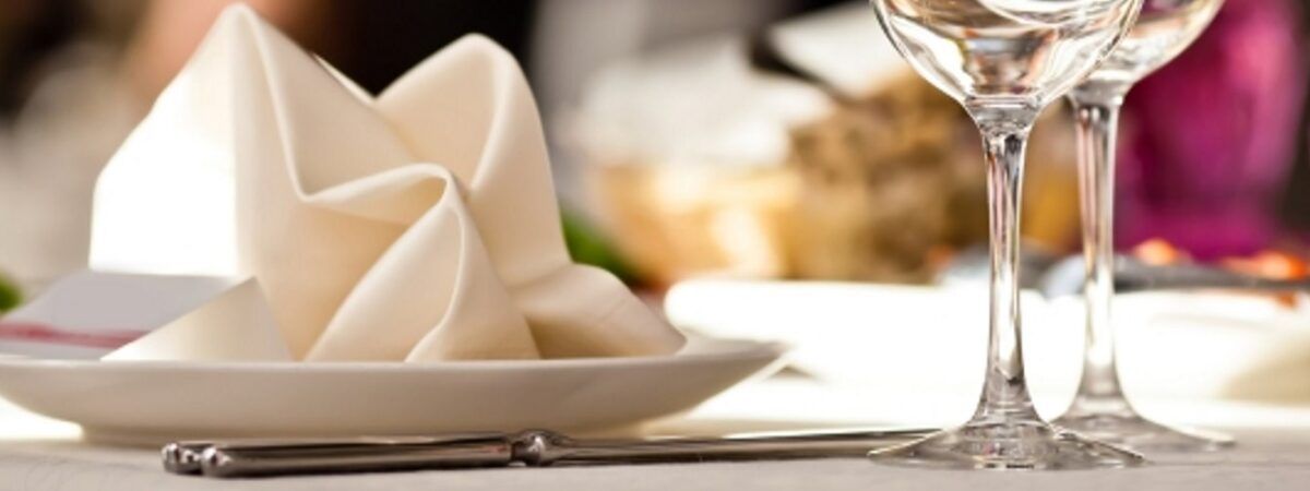 A napkin and wine glasses are on a table.