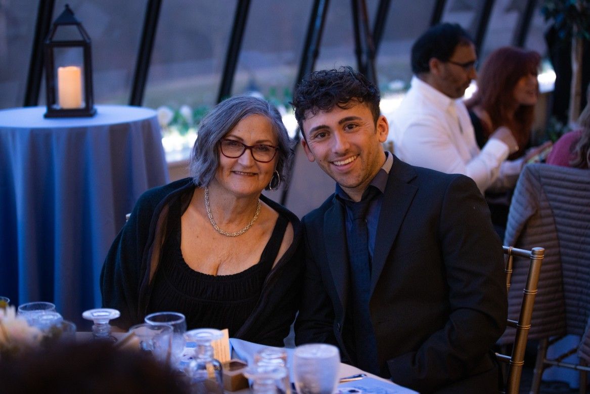 A man and a woman are sitting at a table at a wedding reception.