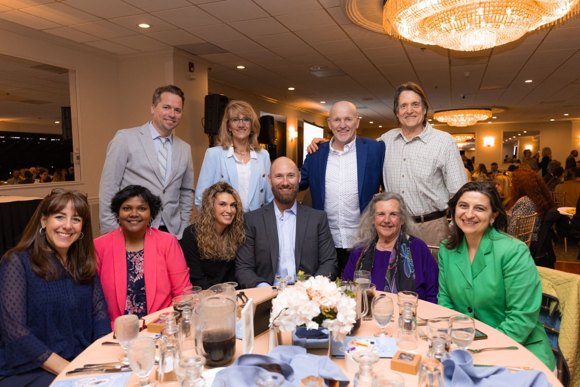 A group of people are posing for a picture at a table.