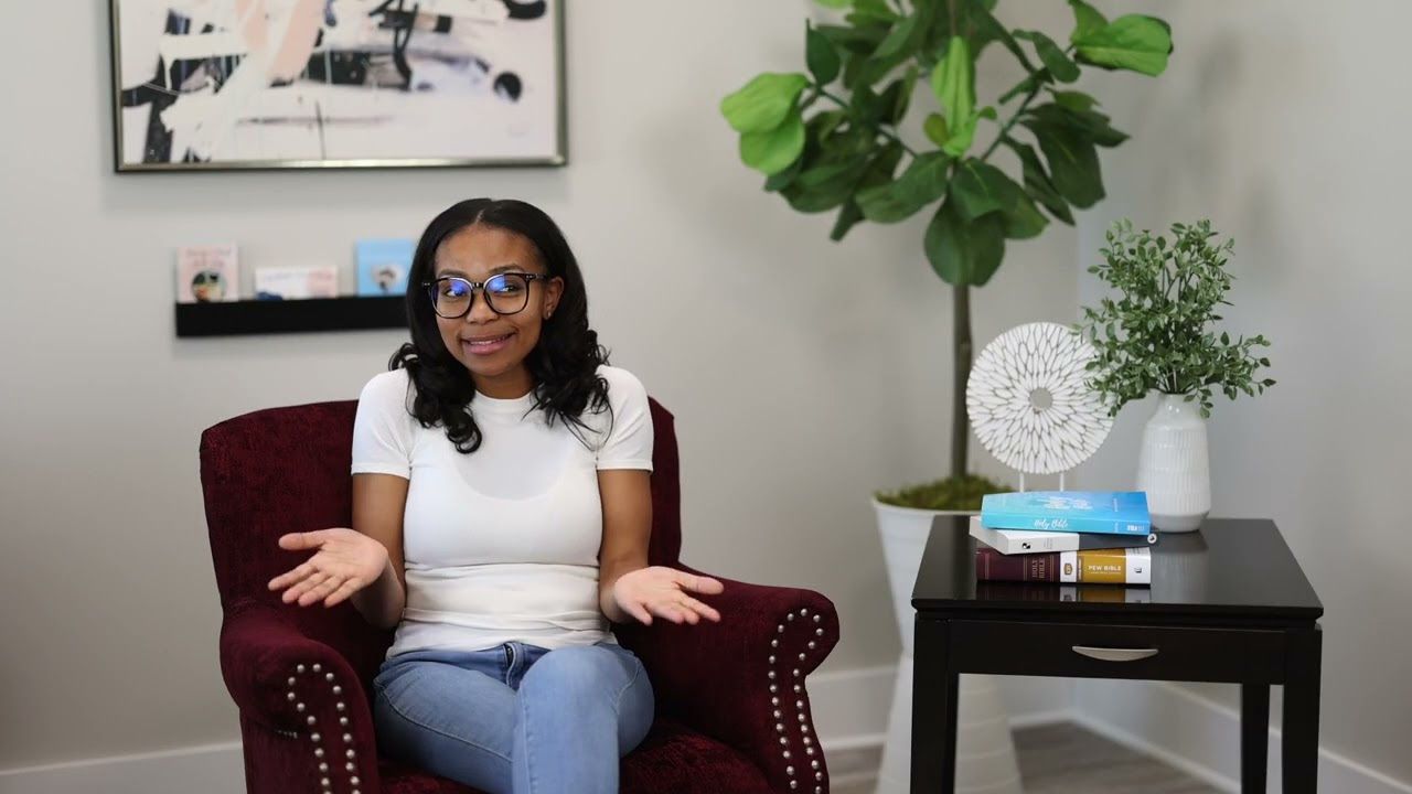A woman is sitting in a chair in a living room.