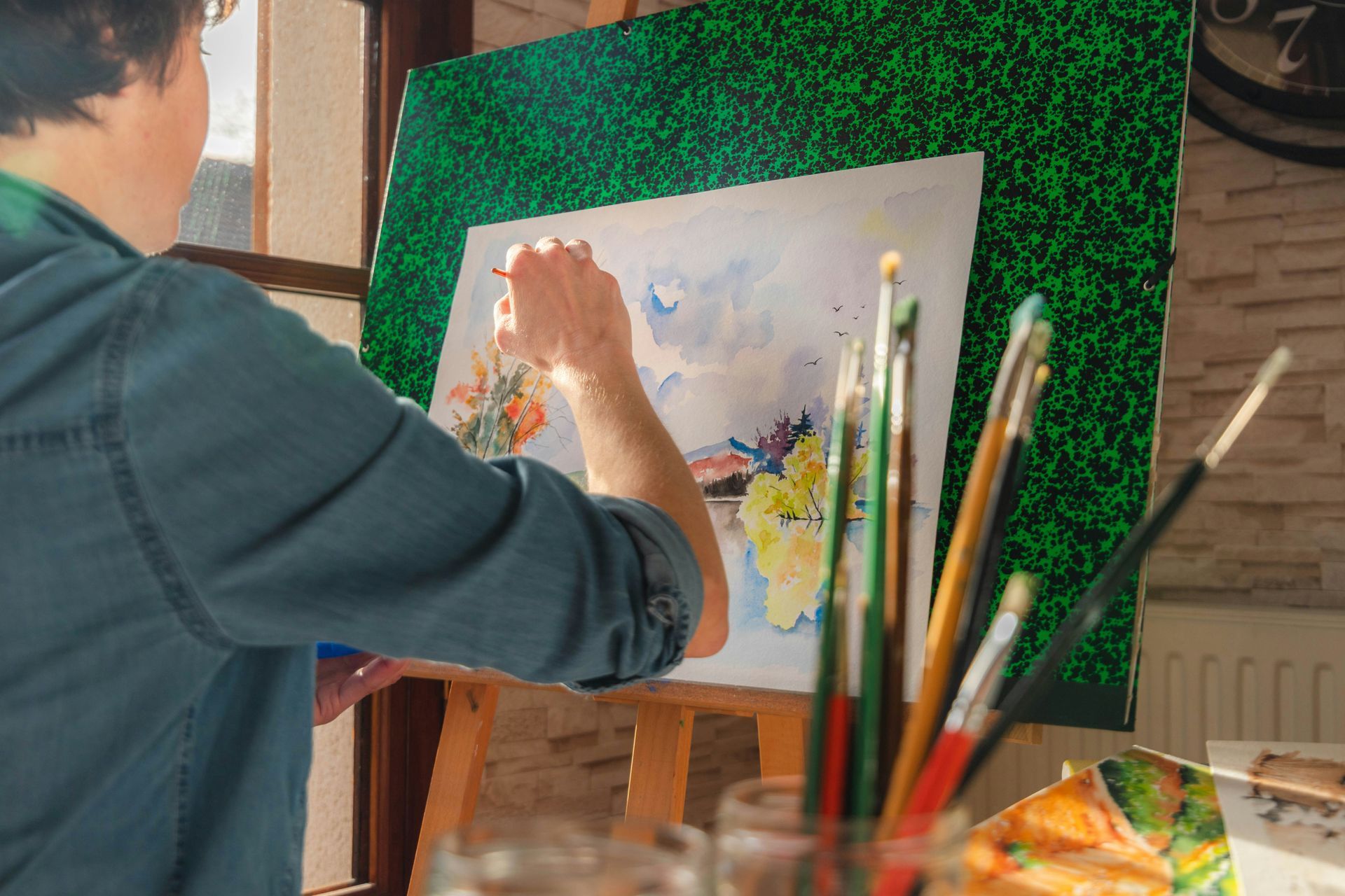 Woman painting with watercolor to help calm herself and boost her mental health. Art Therapy. 