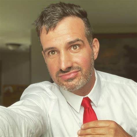 A close up of a woman 's face with a field of flowers in the background.