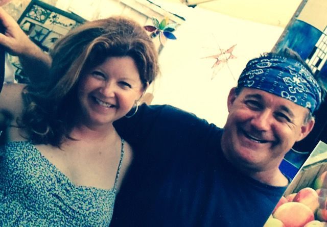 A man and a woman are posing for a picture and smiling