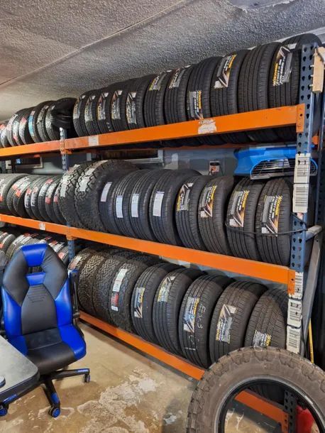 A warehouse filled with lots of tires and a chair