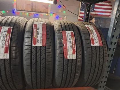 A bunch of tires are stacked on top of each other on a shelf.