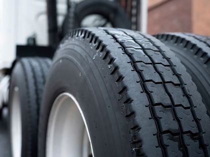A close up of a truck tire with a white rim