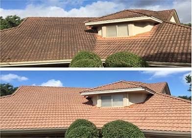 Person pressure washing a house's roof and siding; water sprays from a nozzle.