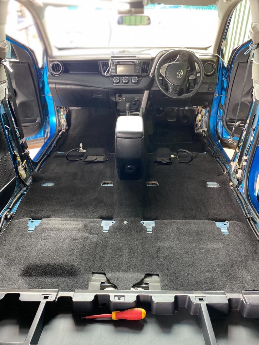 Car interior stripped for renovation, with exposed blue door frames and removed rear seats — Beclean Auto Detailing in Mareeba, QLD