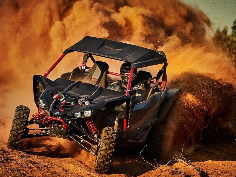 Man Riding Off-Road Vehicle With Sand Behind — Motorcycle Dealer in Berrimah, NT