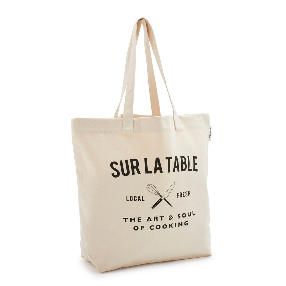 A white tote bag that says sur la table on it