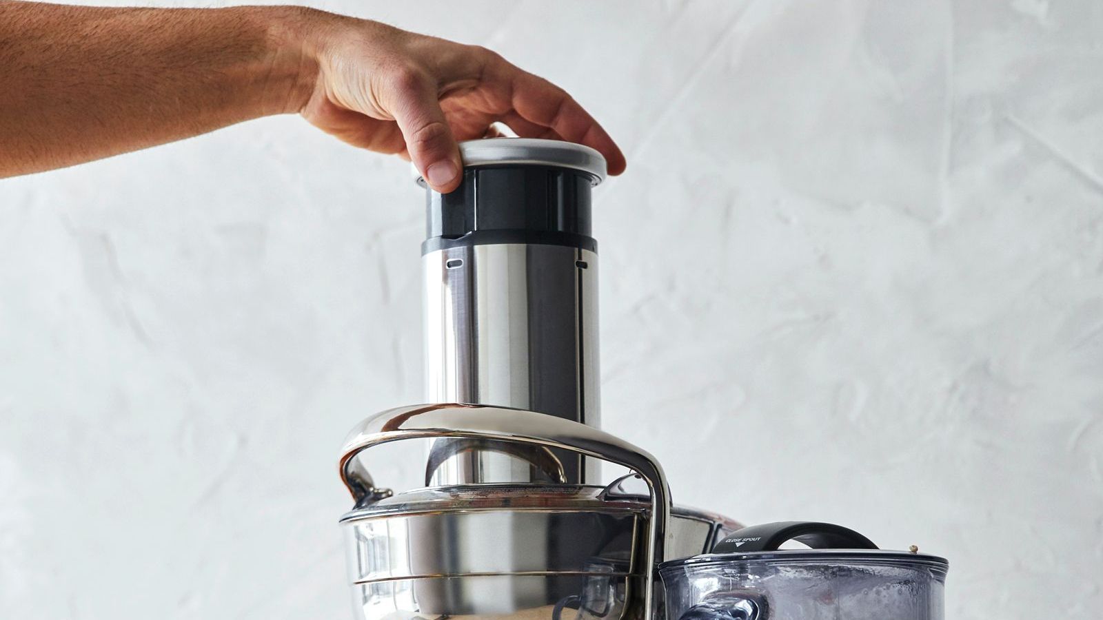 A person is using a juicer to make juice.