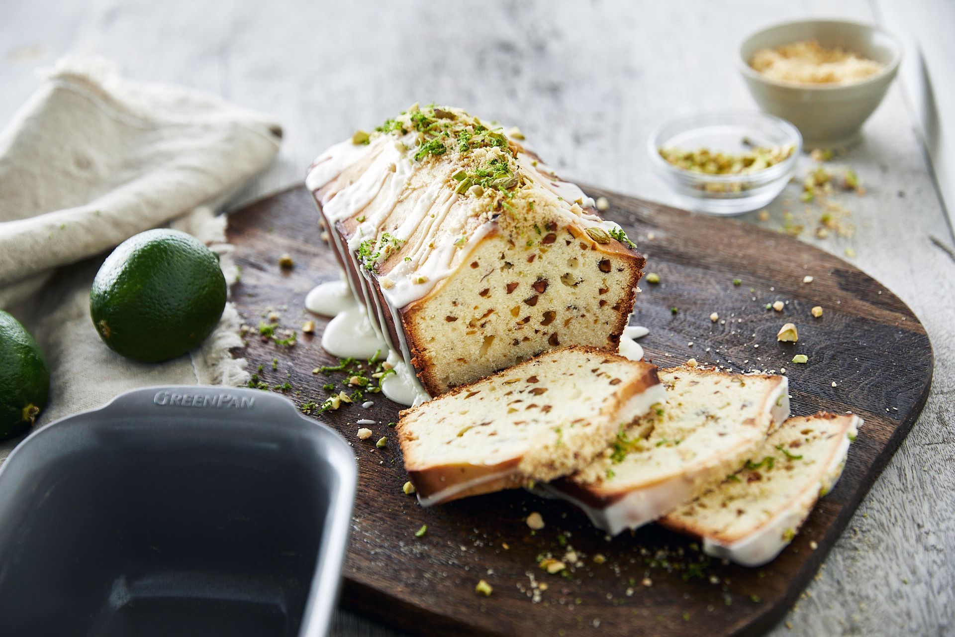 A loaf of cake is sitting on a wooden cutting board.
