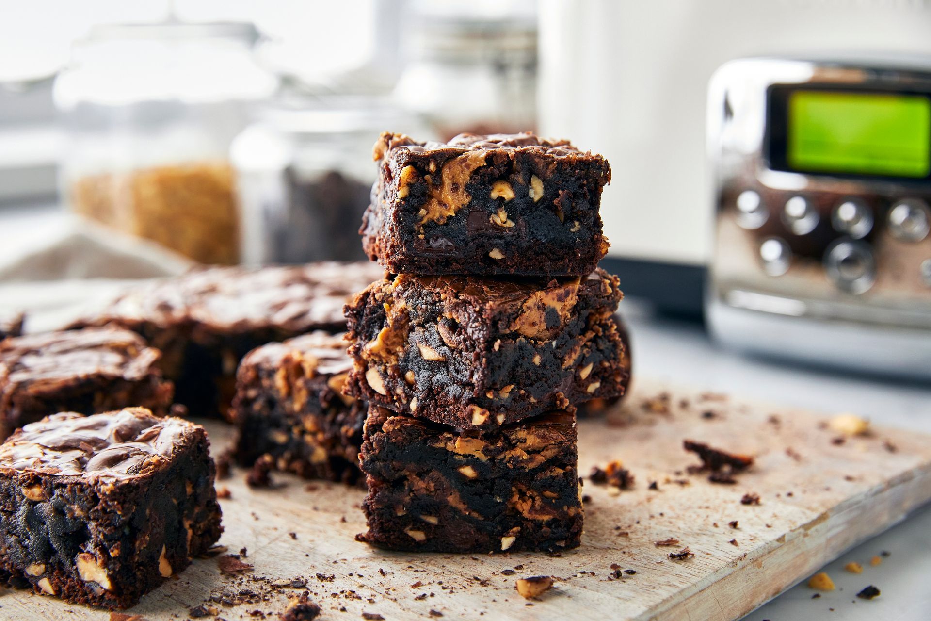 A stack of brownies sitting on top of a wooden cutting board.