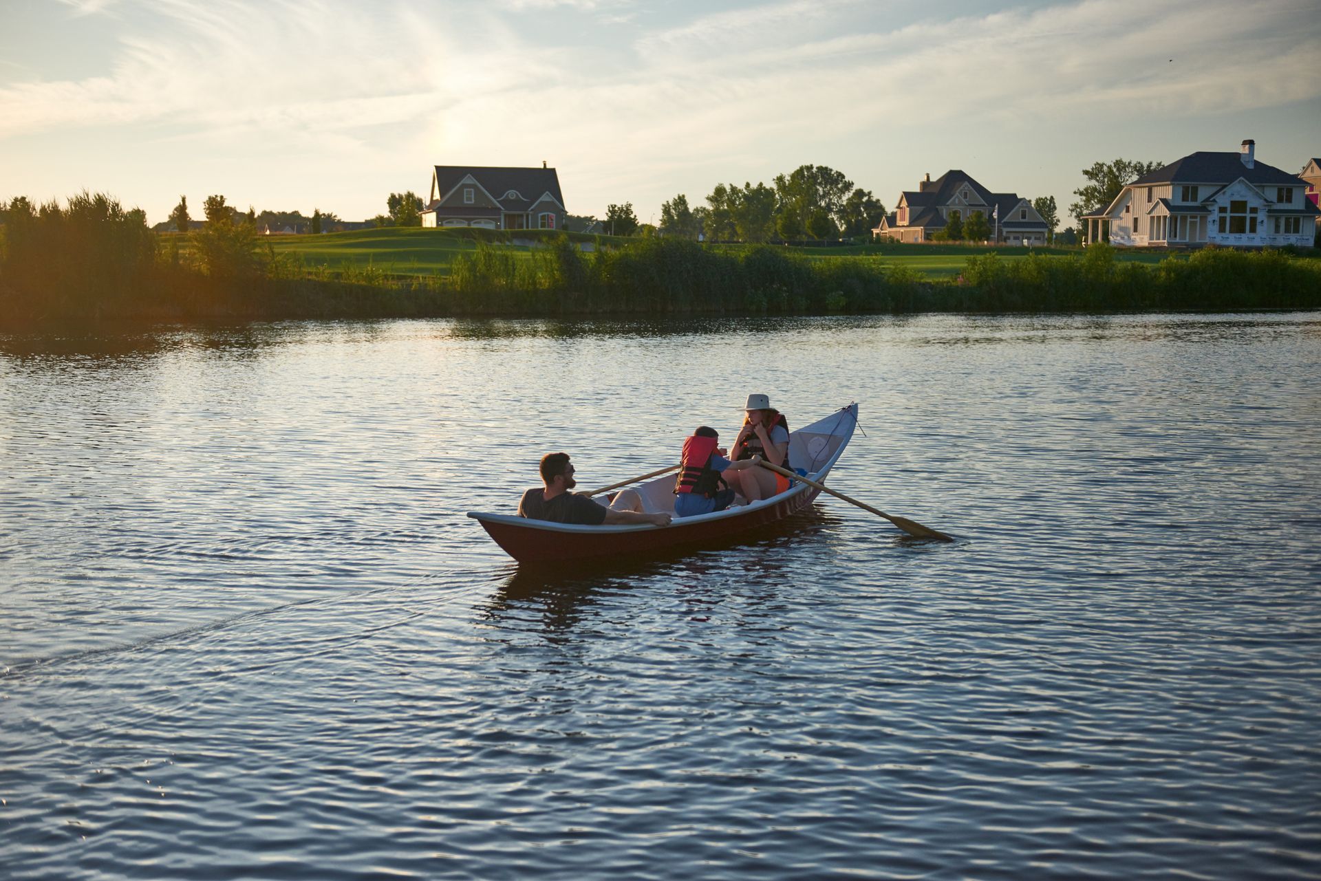 A group of people are rowing a boat on a lake.