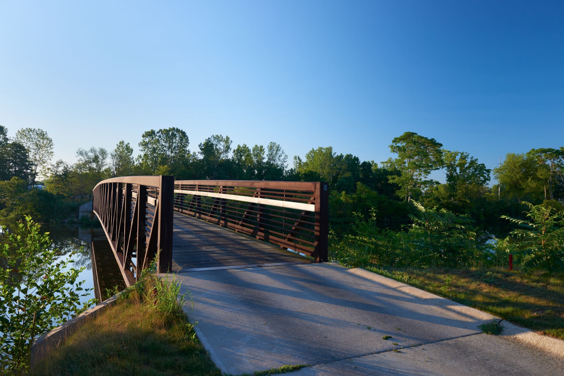 A bridge over a river with trees in the background