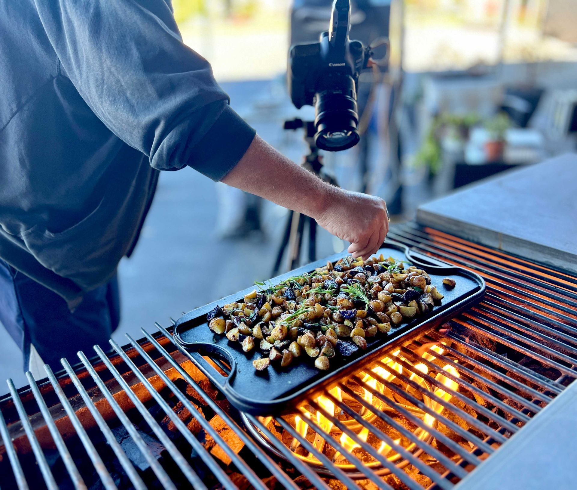 A person is cooking food on a grill .