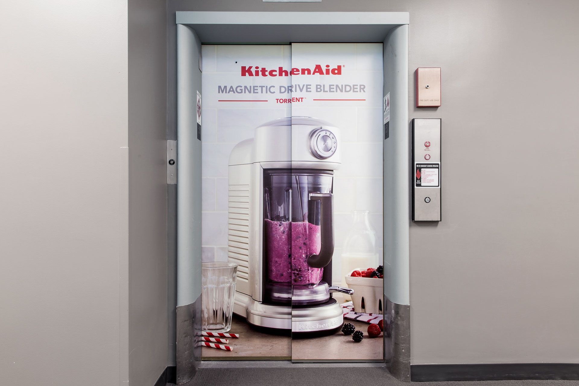 An elevator with a picture of a KitchenAid blender on it used for an internal product launch campaign