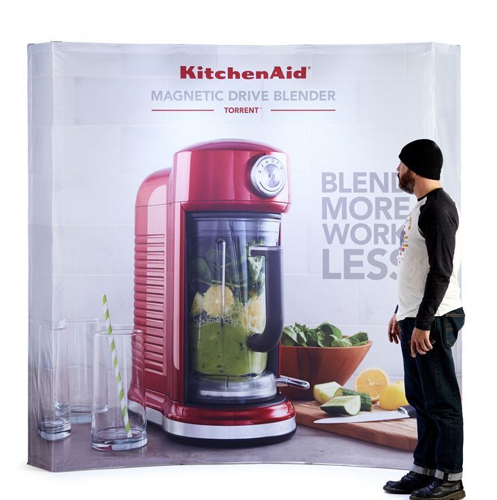 A man standing in front of a KitchenAid magnetic drive blender