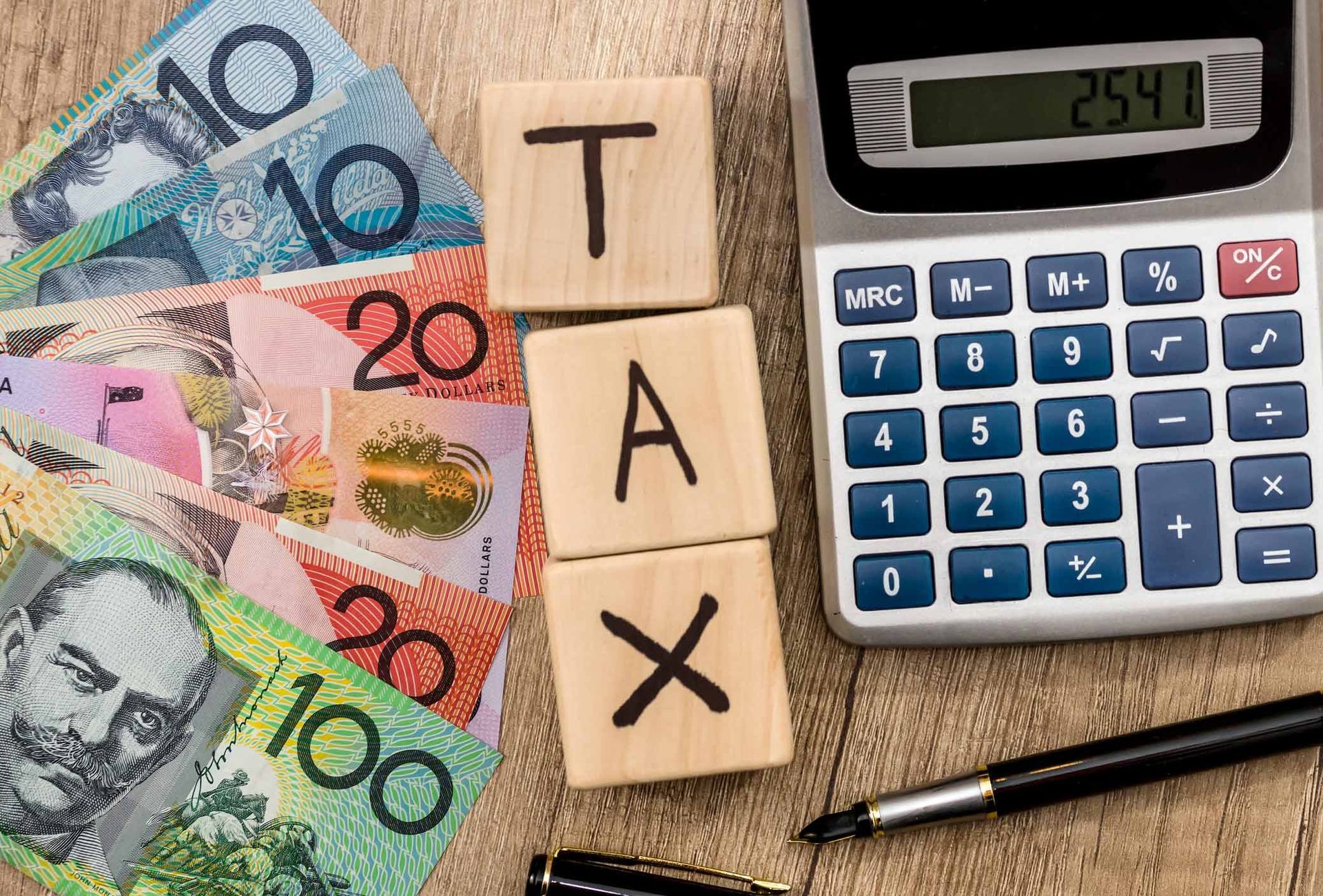Tax cubes with Australian dollar and calculator | Kincumber, NSW | John P Smith & Co