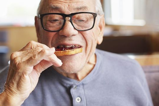 Old Man eating a toast