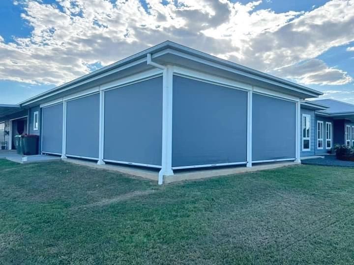 A large house with a lot of windows and a lawn in front of it.