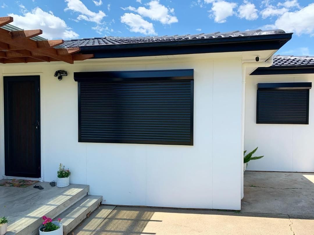 A white house with black shutters on the windows
