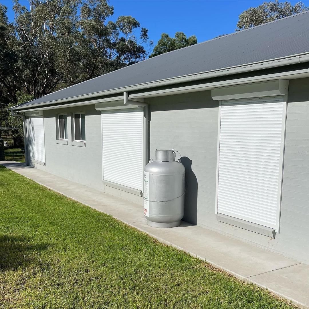 A house with a propane tank on the side of it