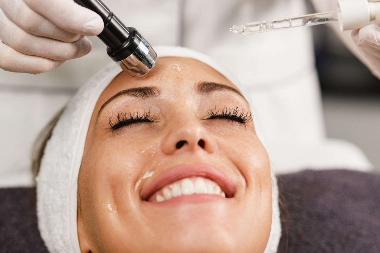 A woman is getting a facial treatment at a beauty salon.