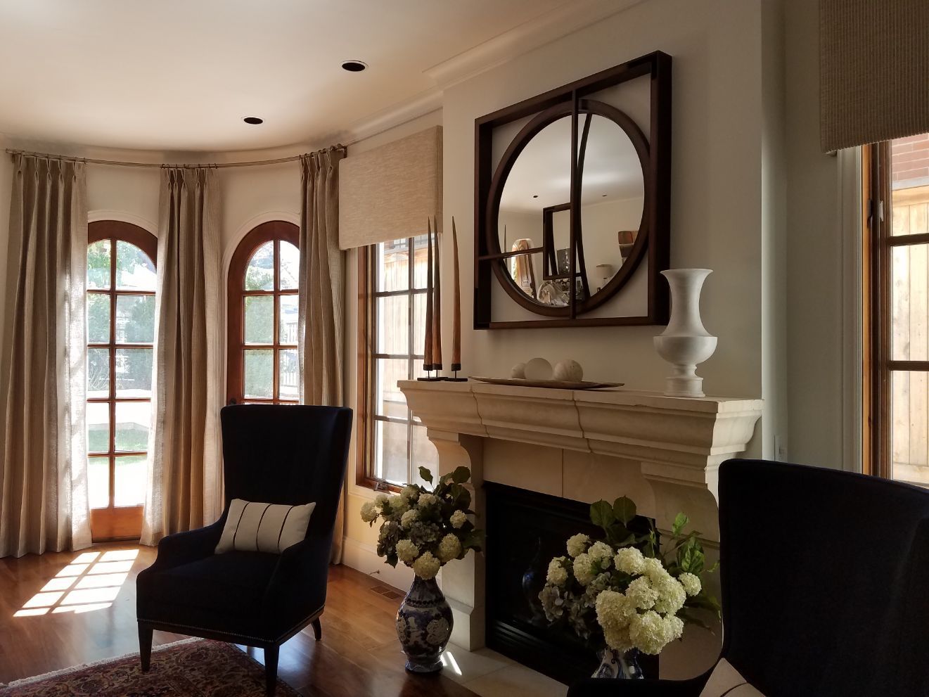 A living room with a fireplace and stylist curtains