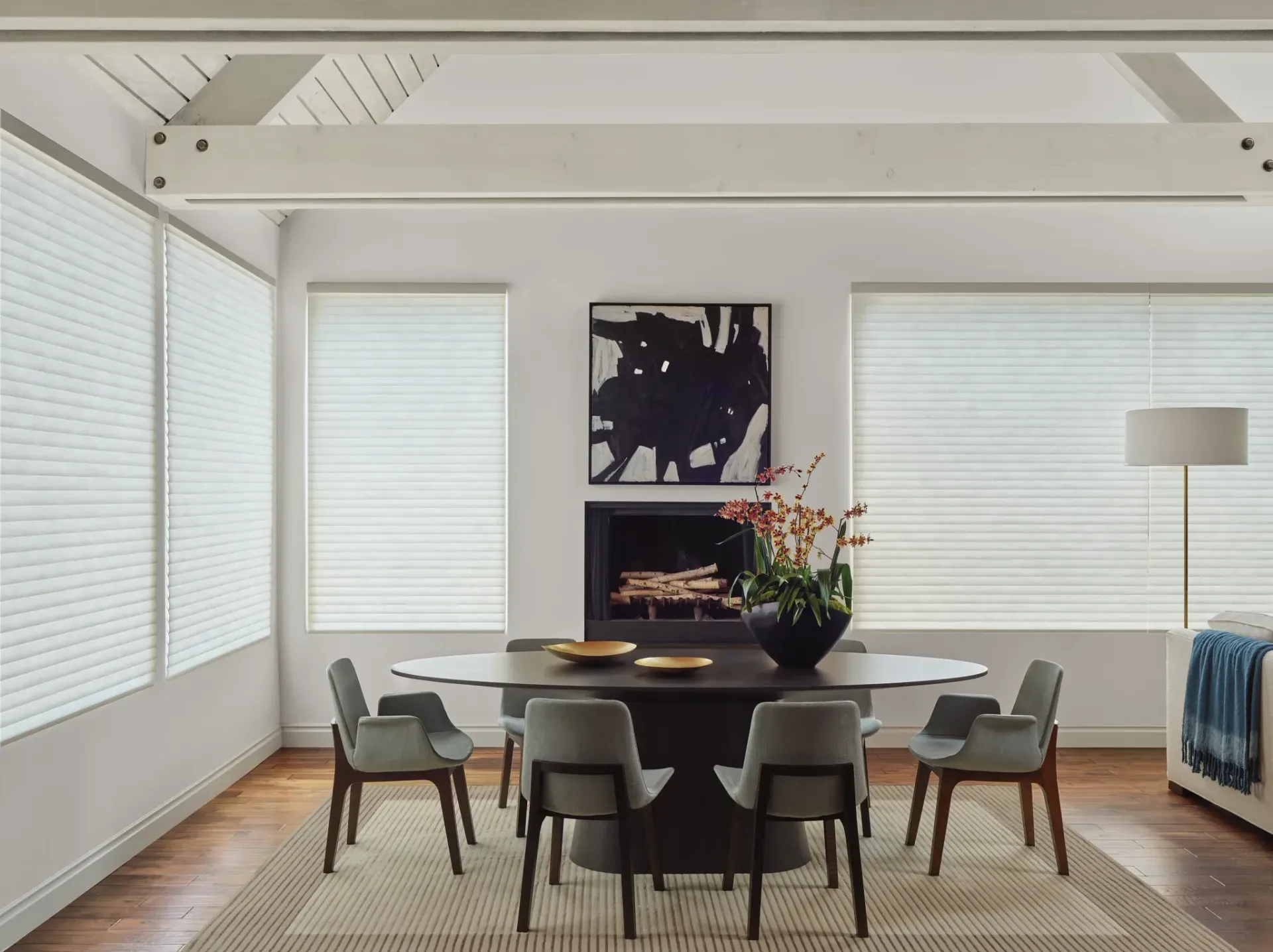 A dining room with a table and chairs and a fireplace