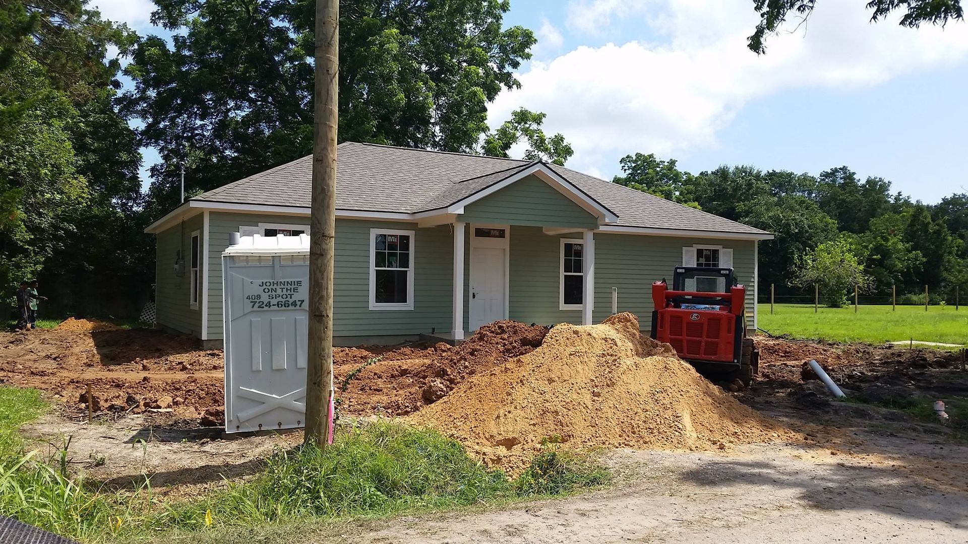 A small house with a portable toilet in front of it