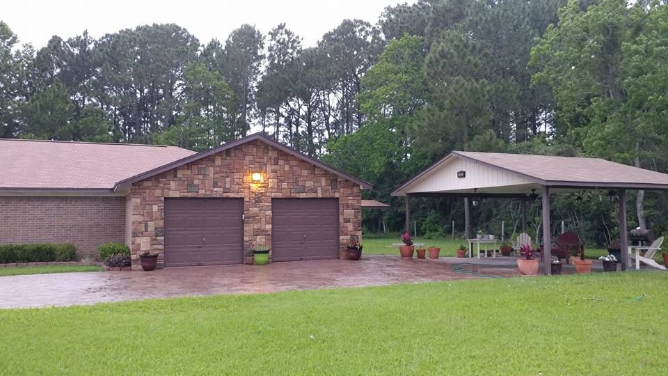 A house with two garage doors and a porch