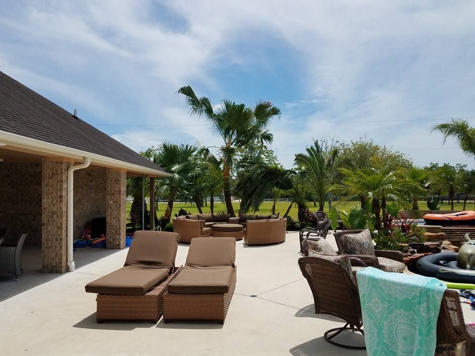 A patio with a lot of chairs and a towel on it