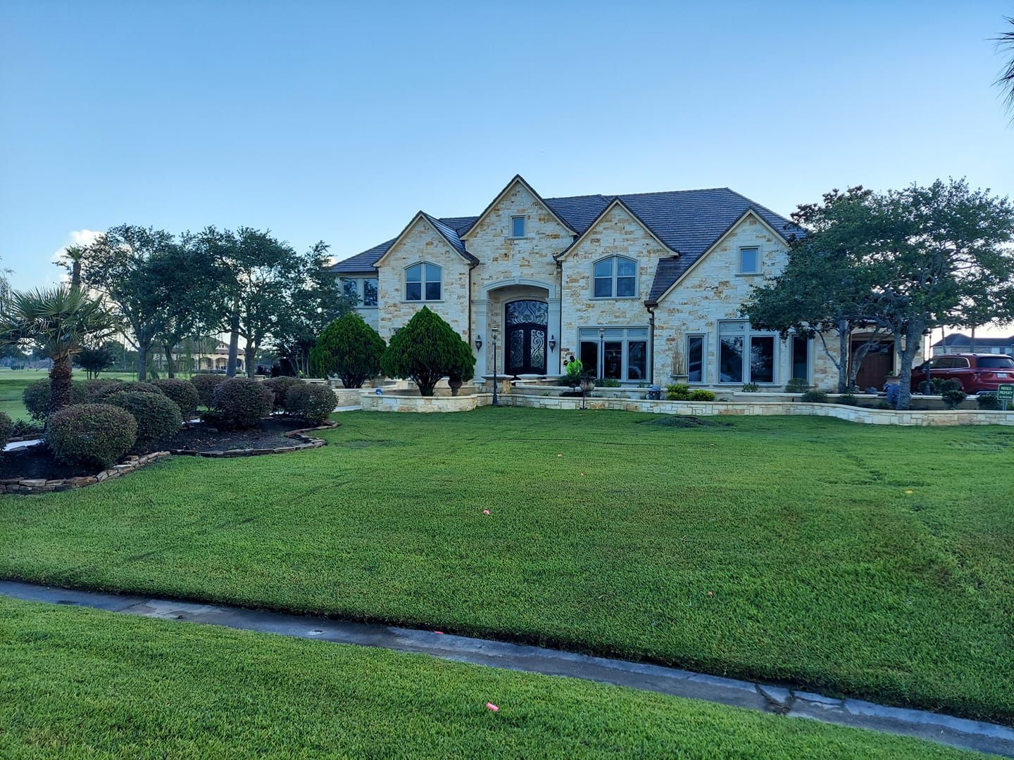 A large house with a lush green lawn in front of it