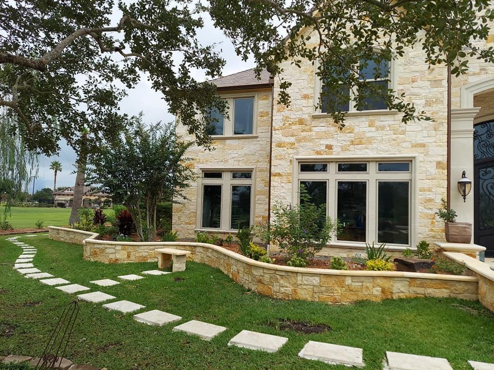 A large brick house with a walkway leading to it