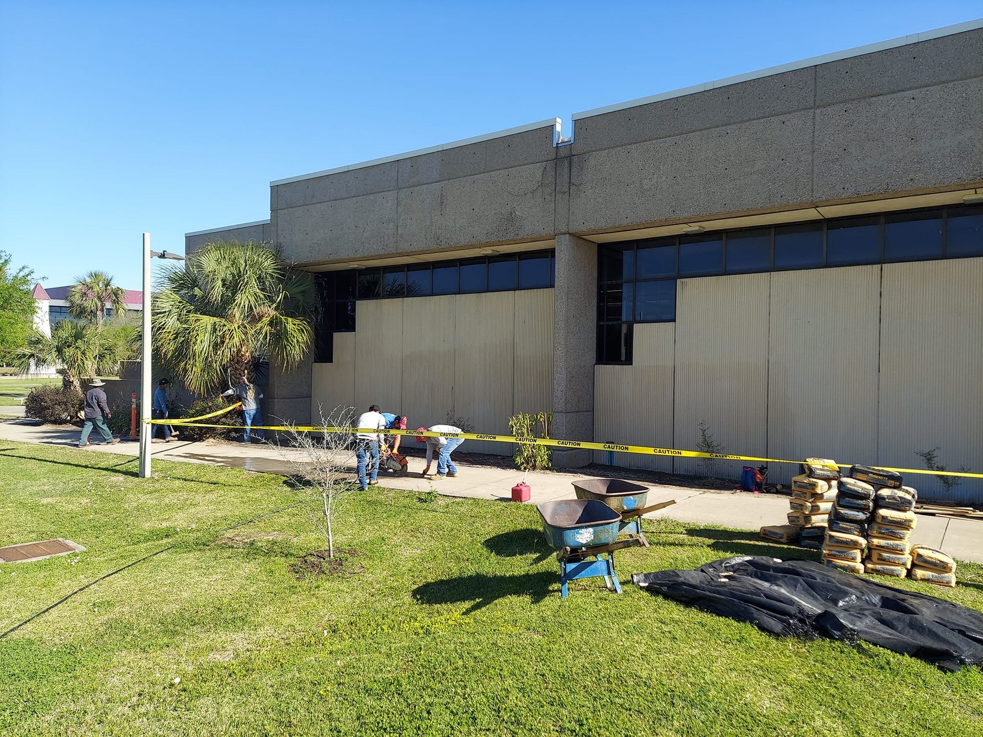 A group of people are working outside of a building