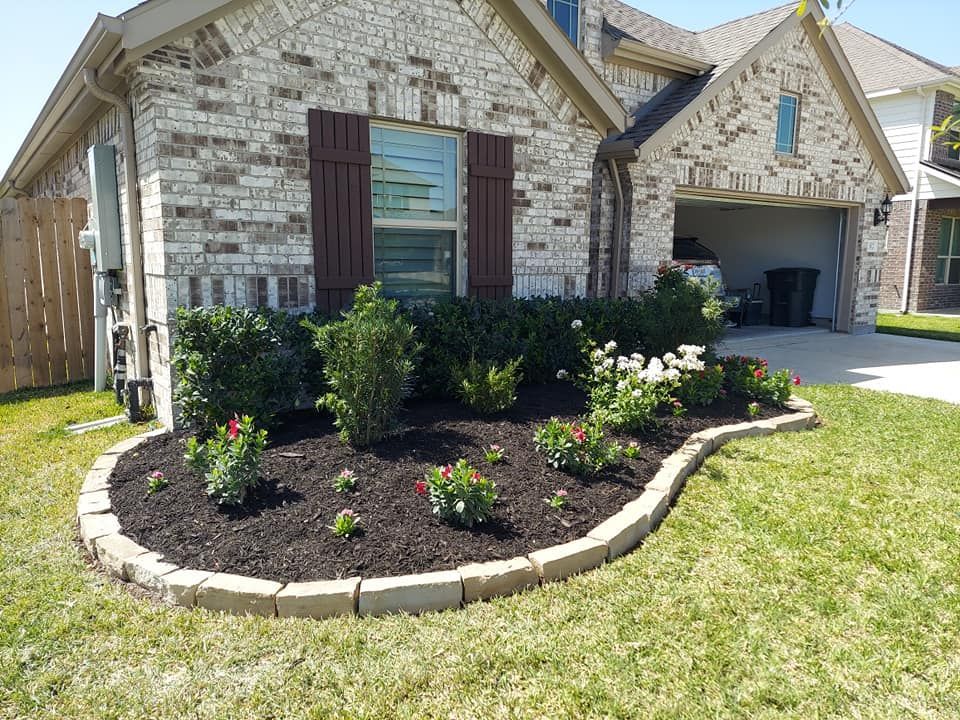A brick house with a garden in front of it.