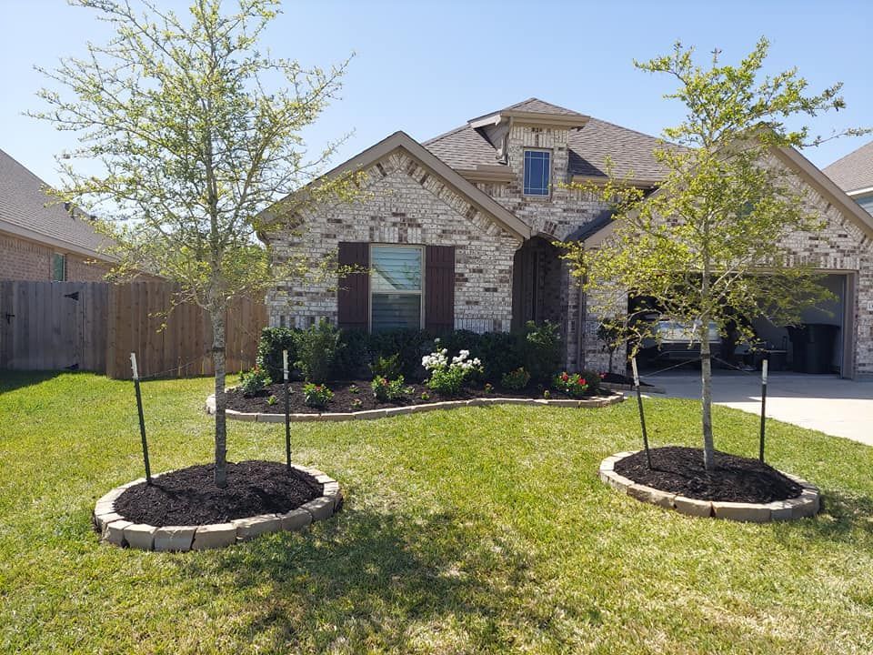 A brick house with two trees in front of it