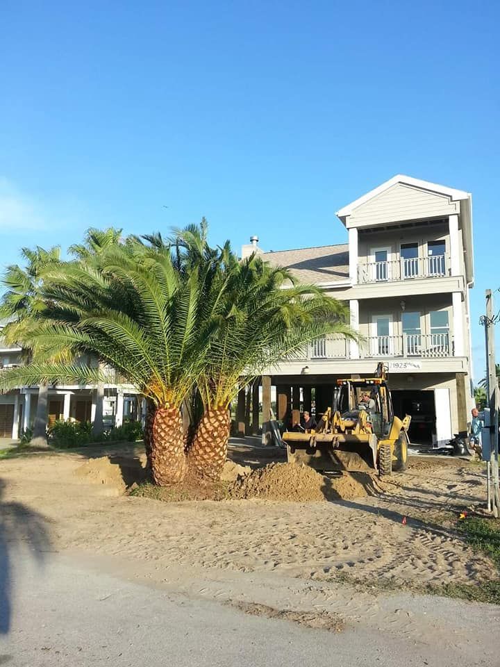 A house under construction with a bulldozer in front of it