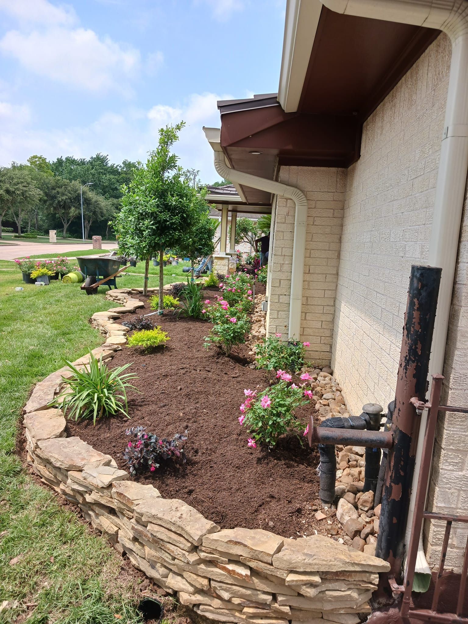 A house with a lot of flowers in front of it.