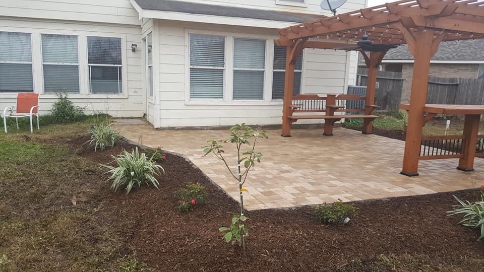 There is a pergola in the backyard of a house.
