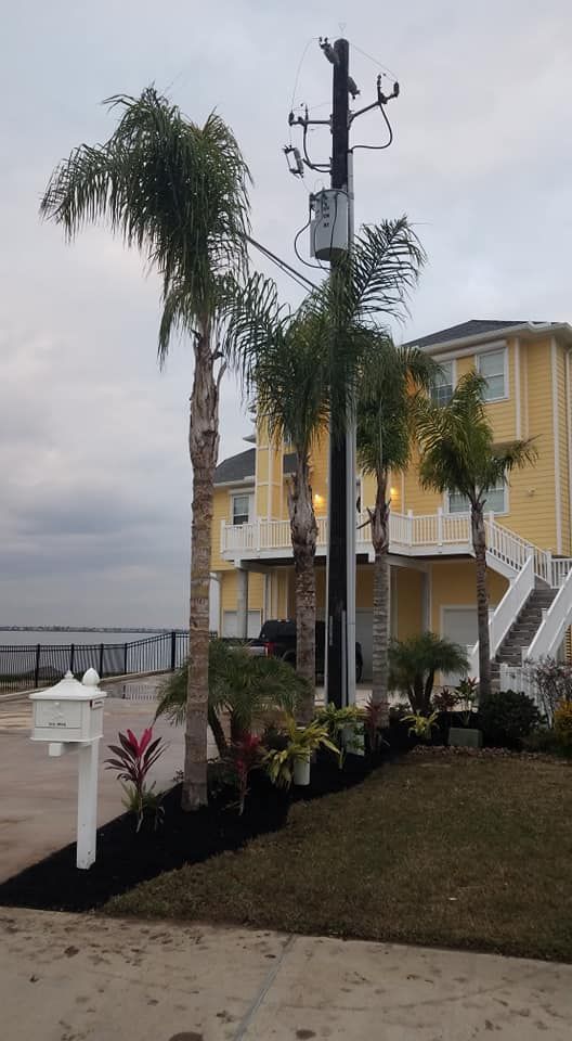A yellow house with palm trees in front of it