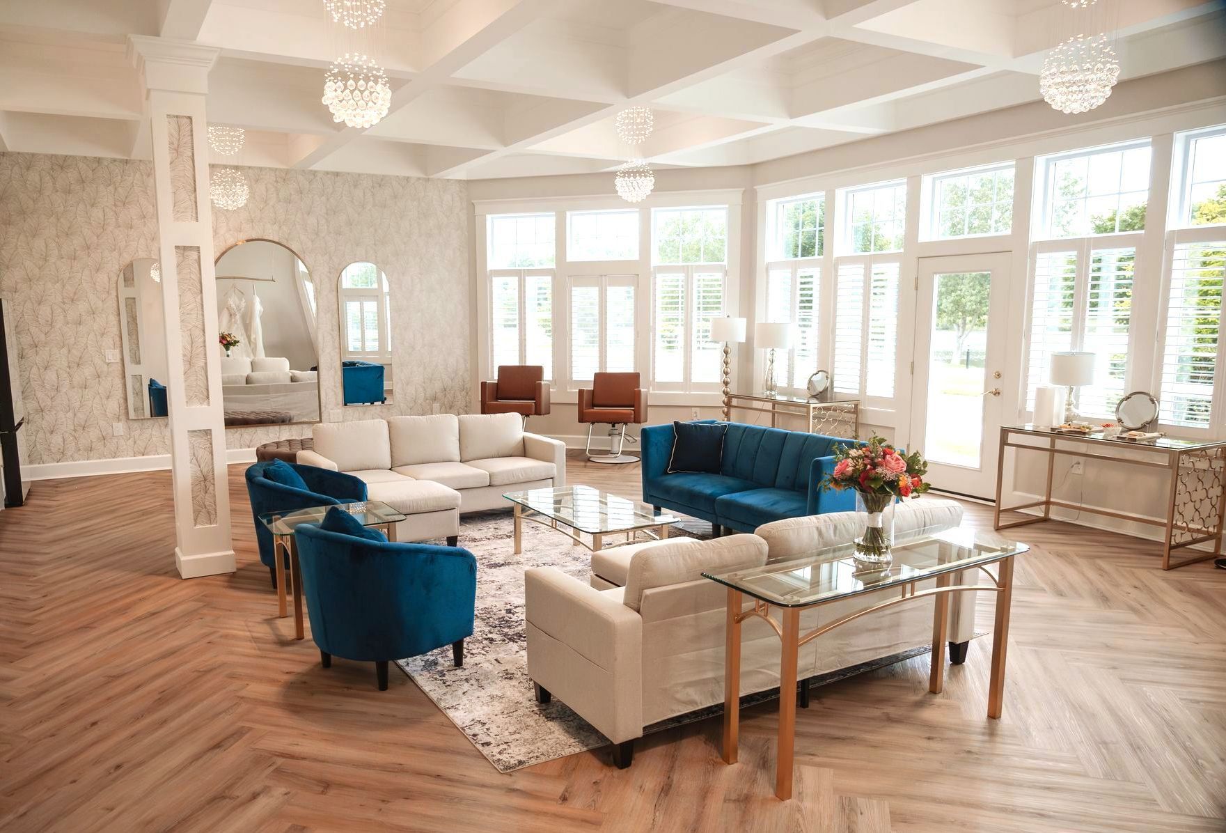 A living room filled with furniture and lots of windows.