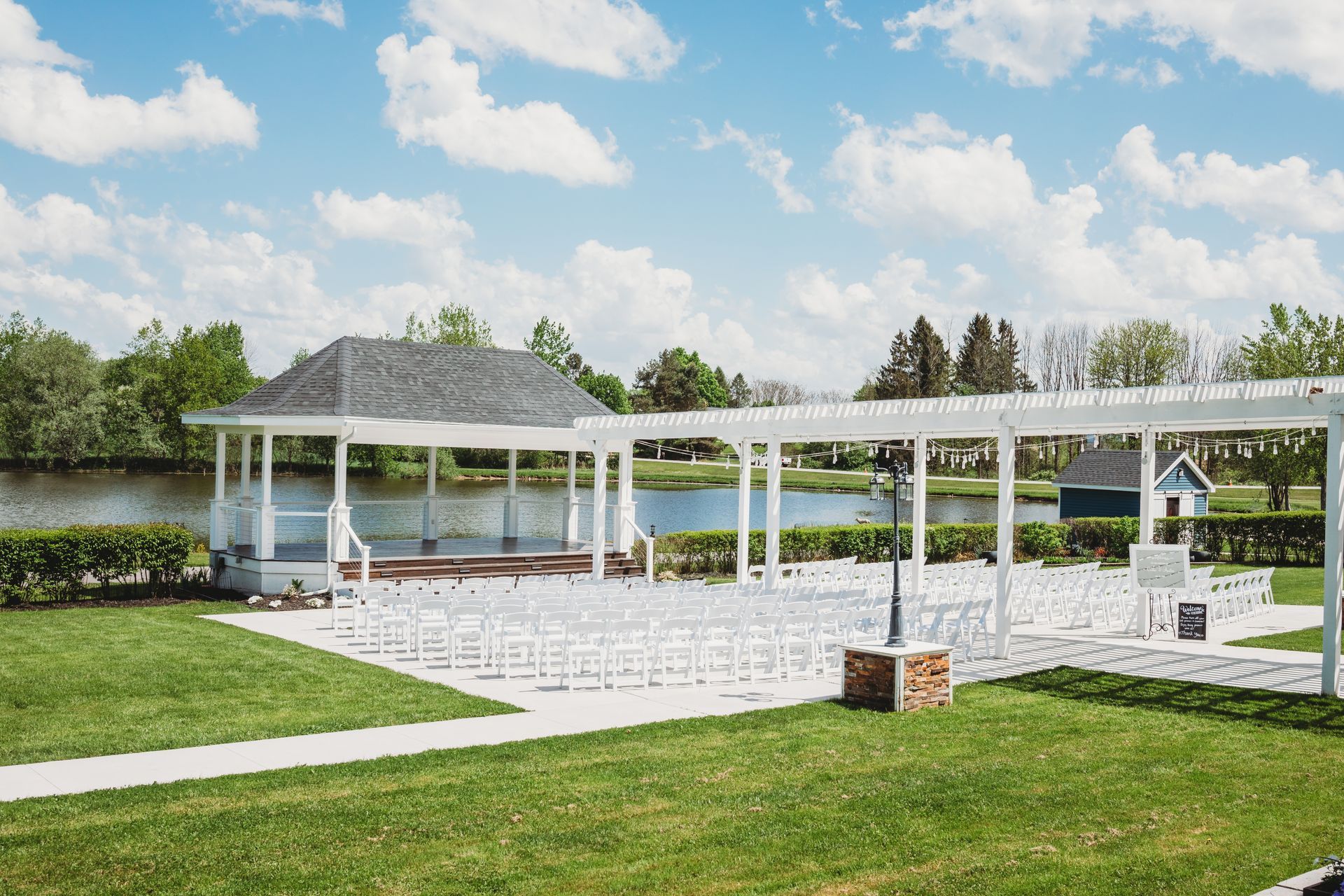 There is a gazebo and chairs set up for a wedding ceremony.