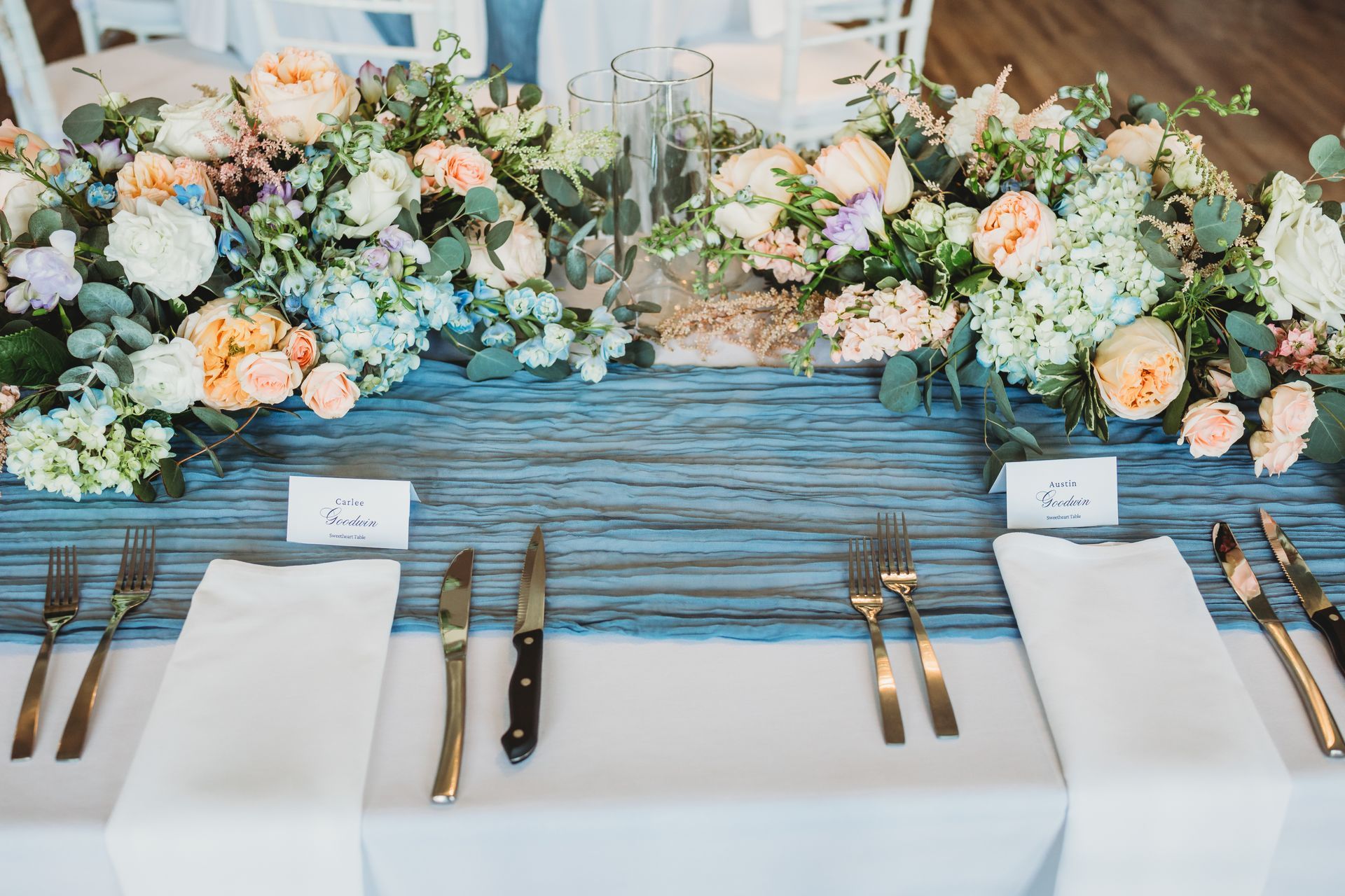 A long wooden table with a vase of flowers on it.