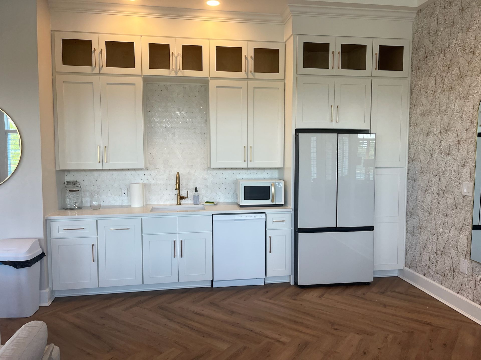 A kitchen with white cabinets and a white refrigerator